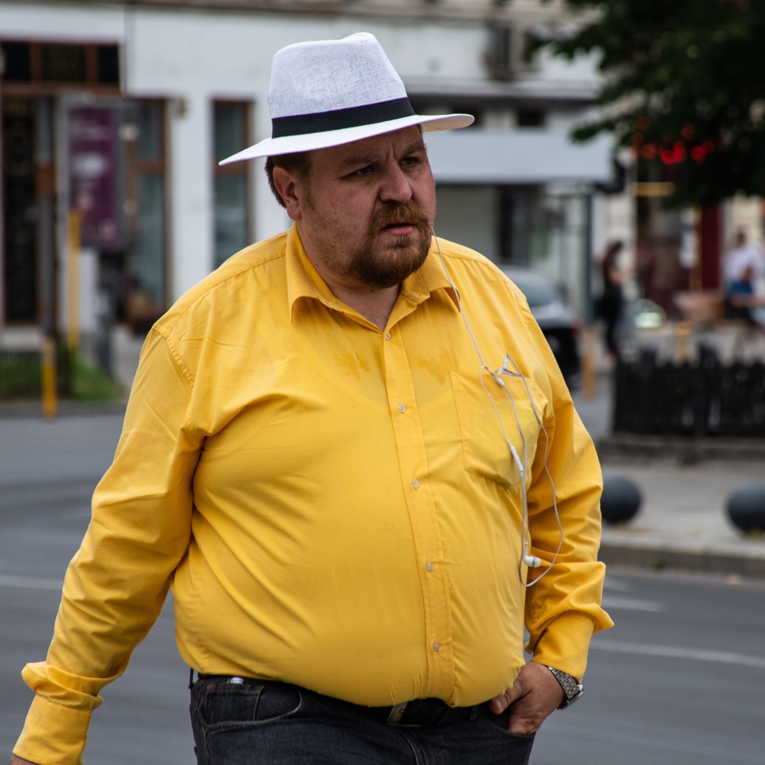 A man in Romain walking to work in a fashionable attire