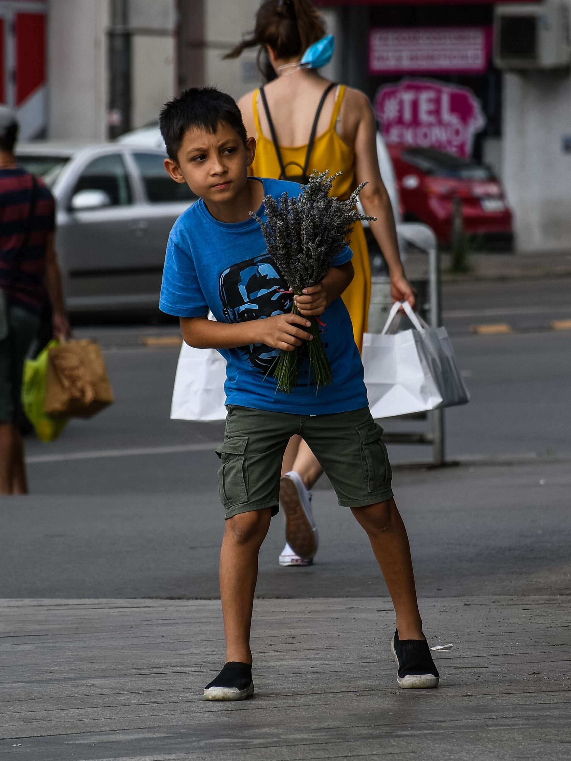 Kidding Looking for Someone with Flowers in His Hands
