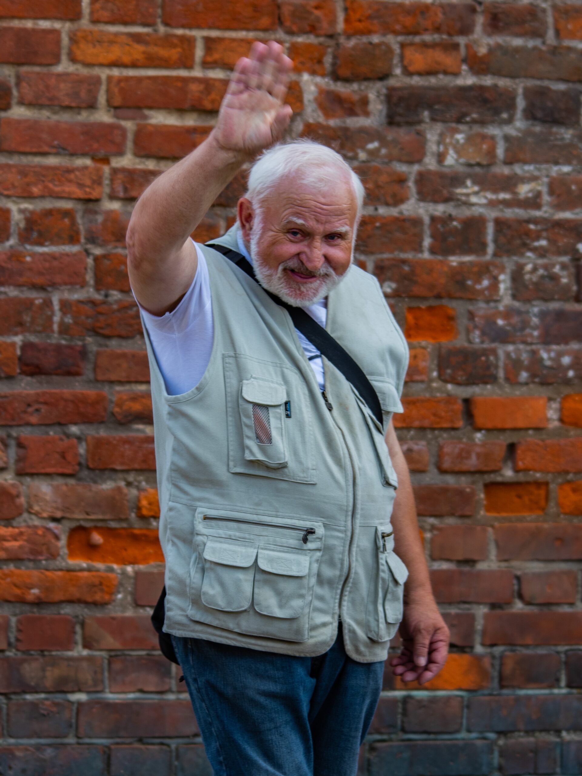 An old Polish man waving at camera for Photograph