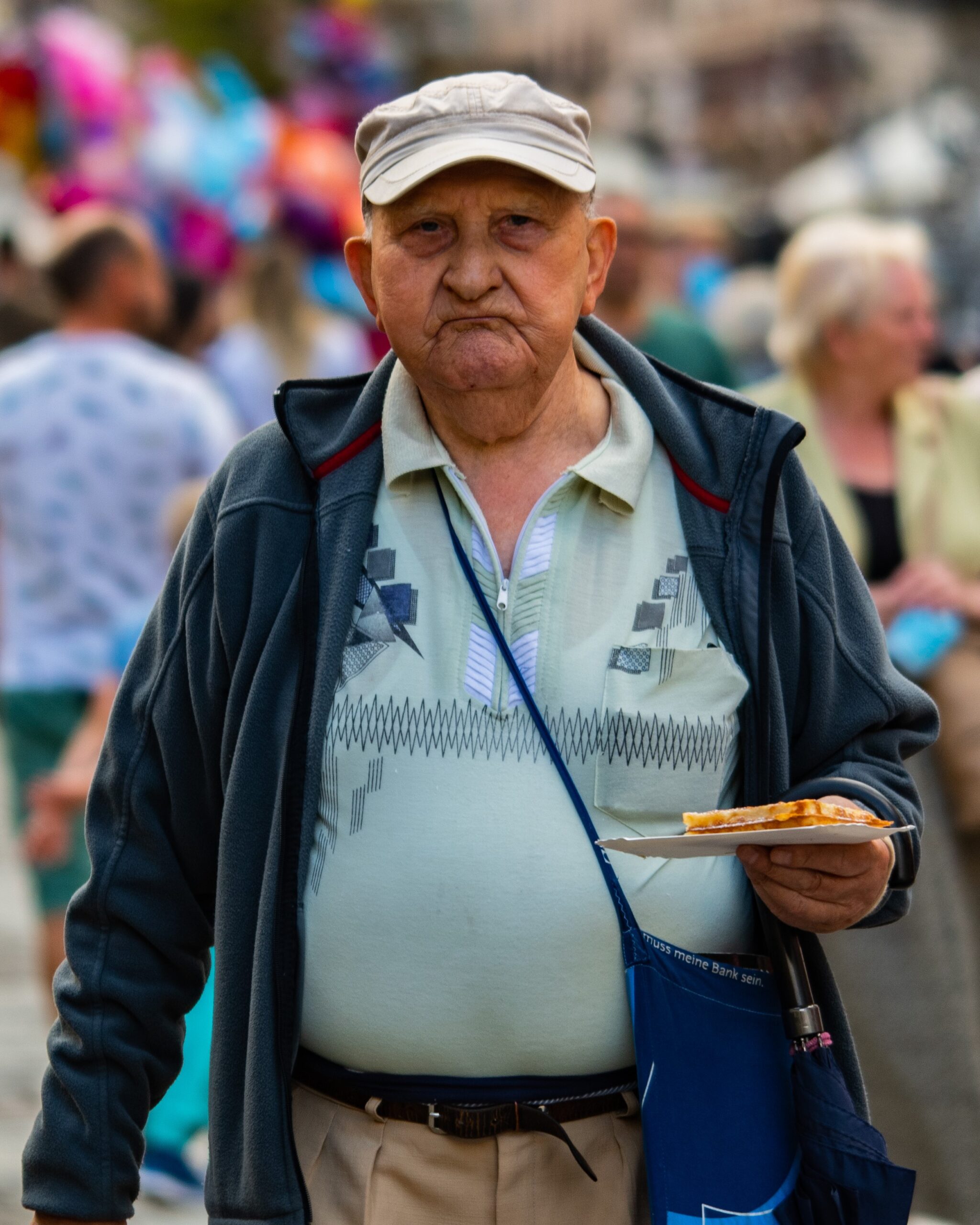 Old Man walking with his fresh street food