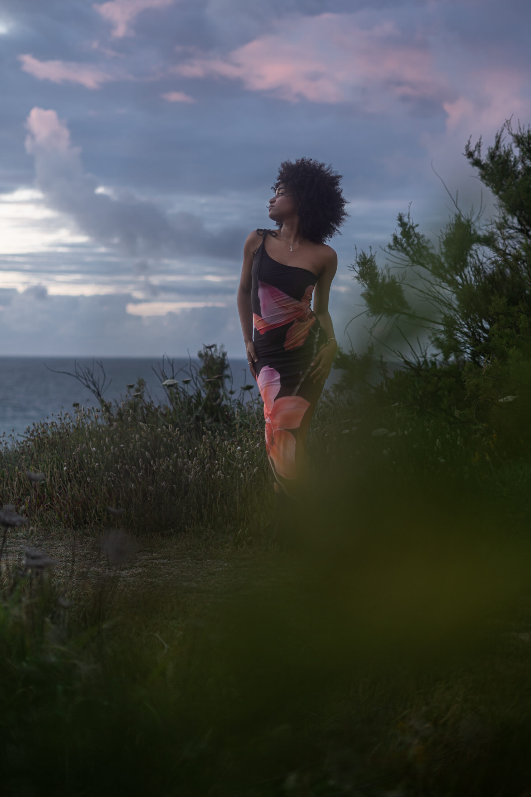 Girl at the cliff looking at sunset