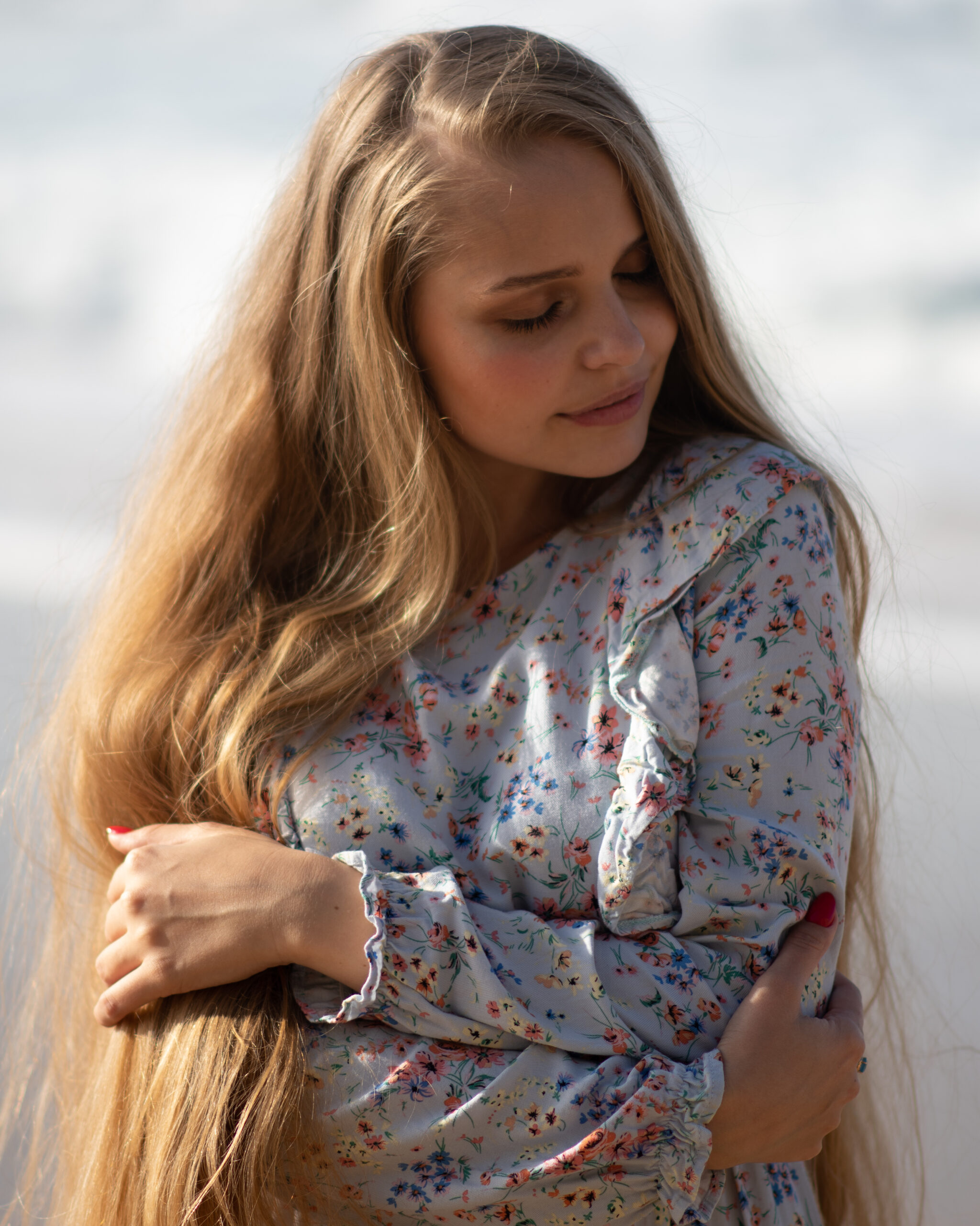 Women Carrasing herself at beach in winter