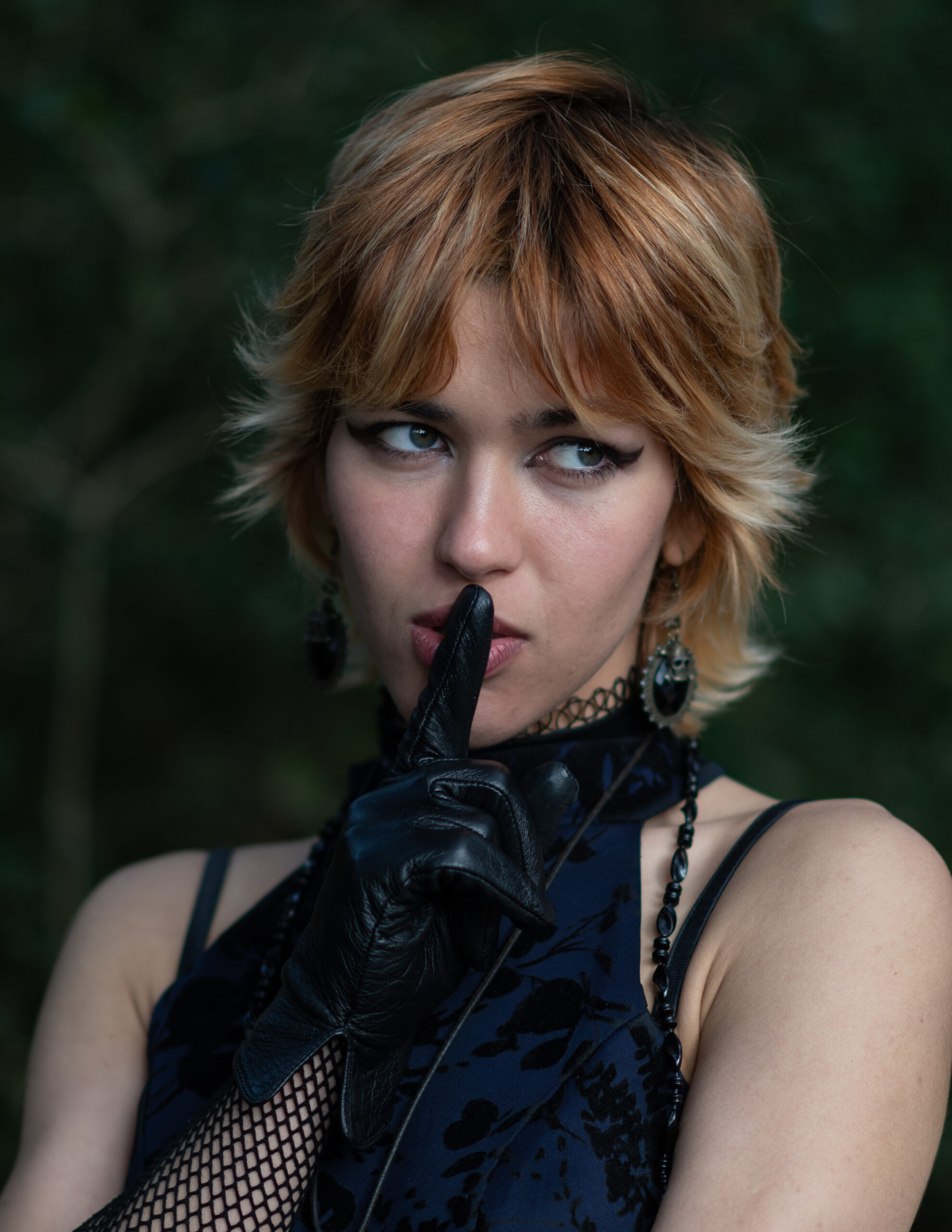 Girl in dark asking you to shush