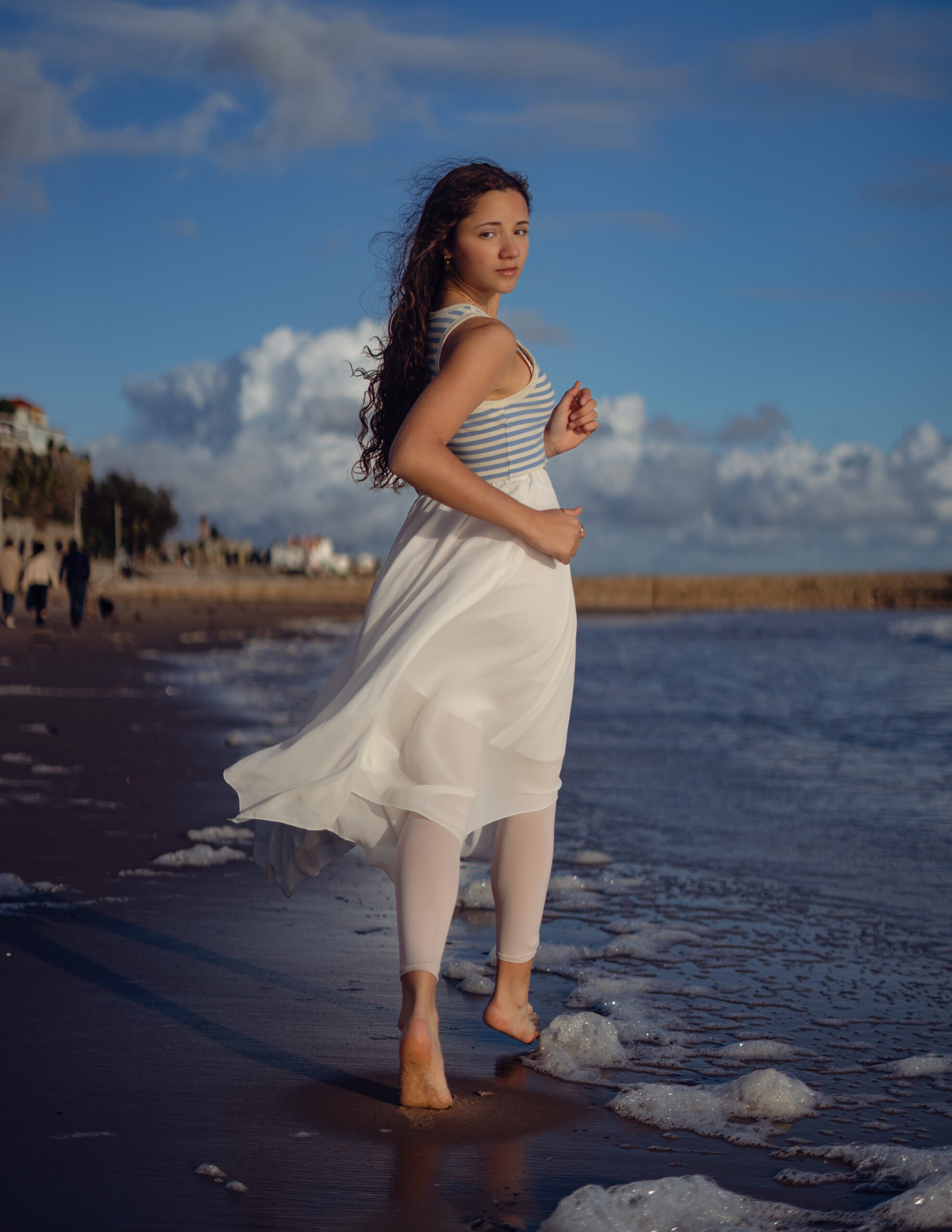 Girl looking back running away at the beach