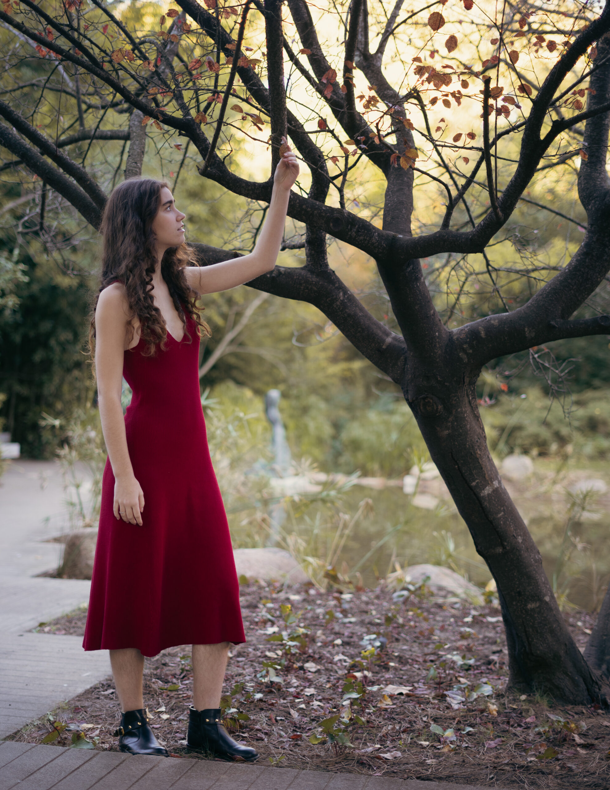 Girl looking at tree during fall