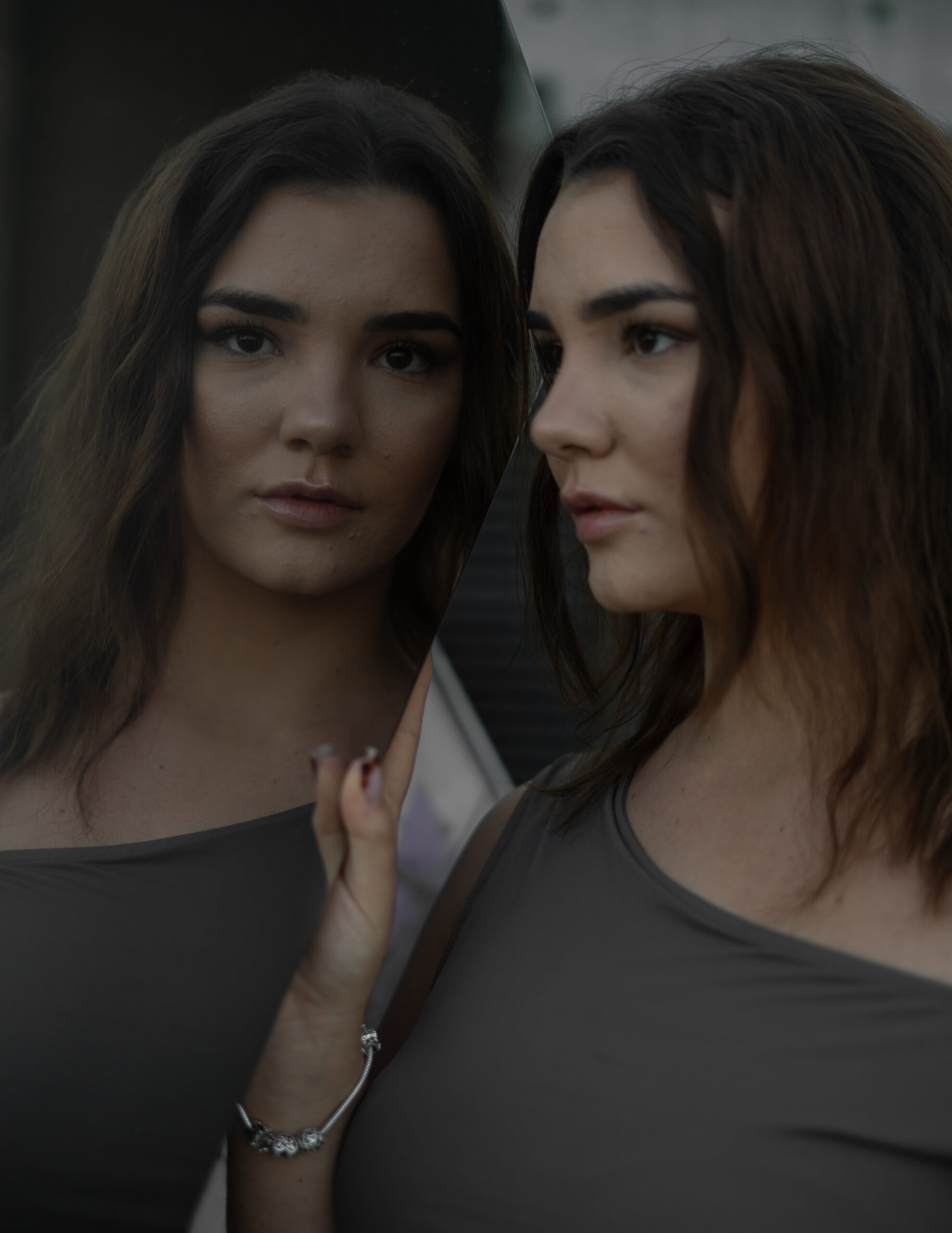Girl looking at the camera through a glass building