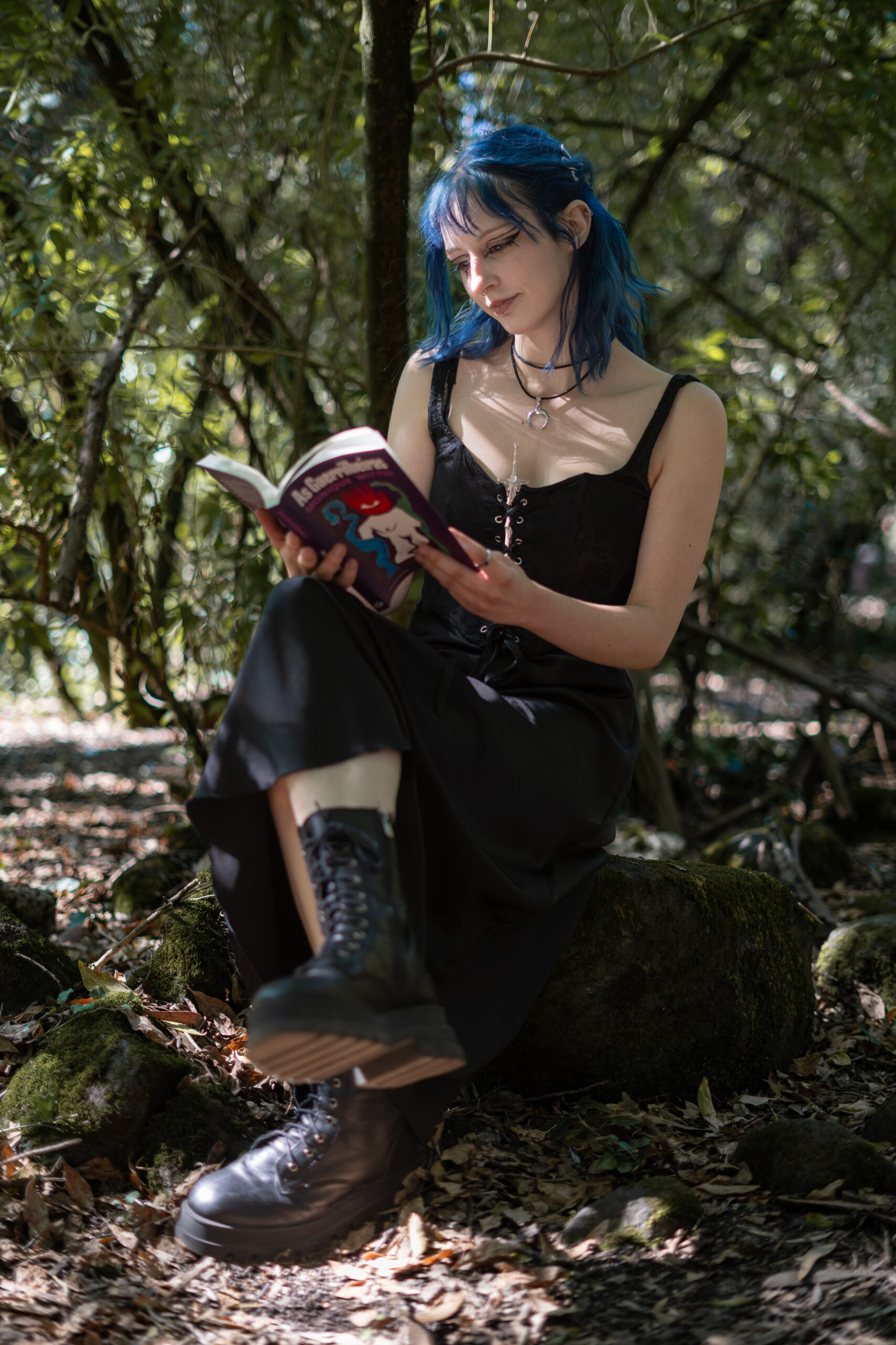 Girl reading a book in middle of forest