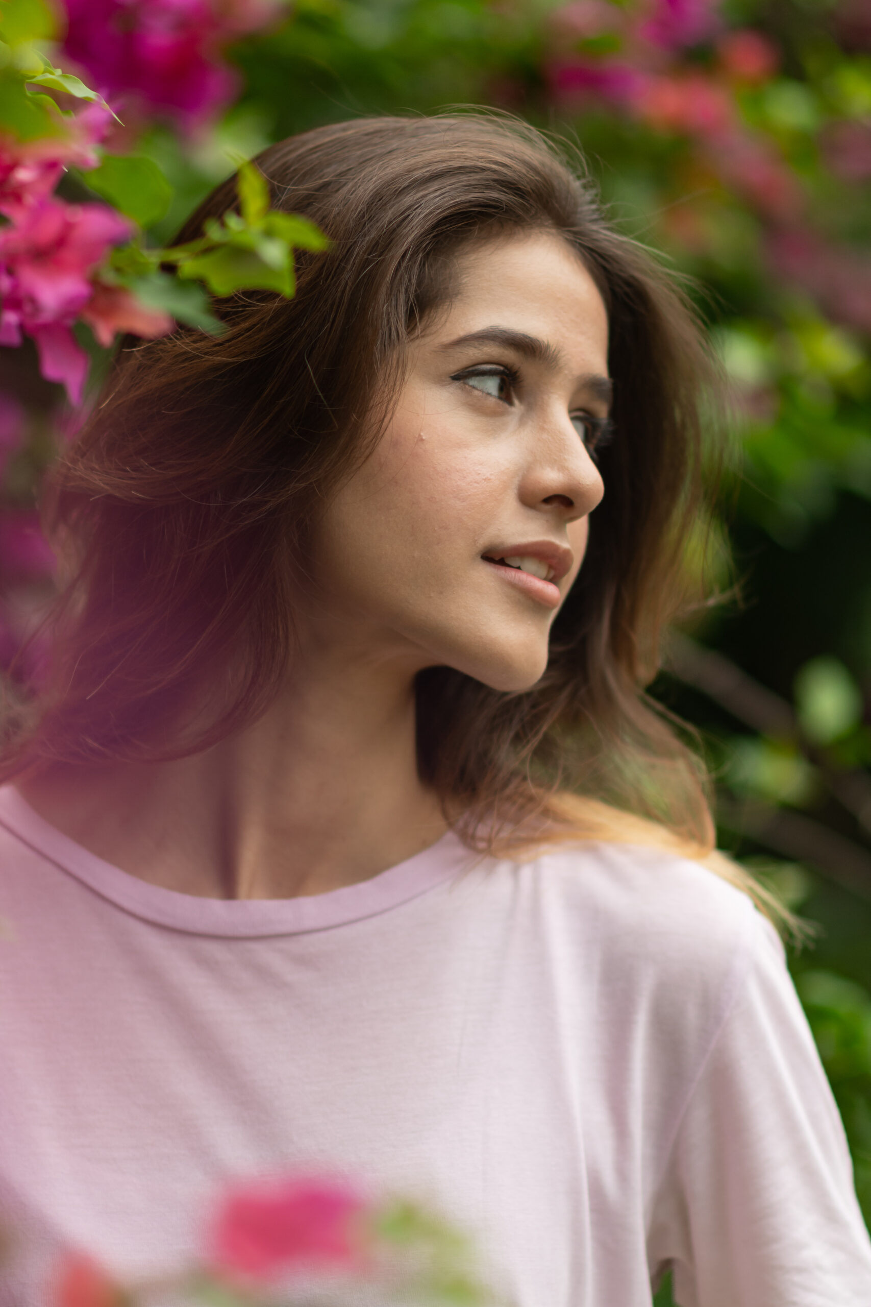 Girl in front of pink flowers
